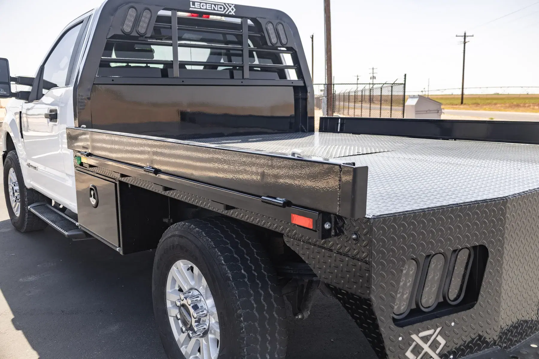 Legend X fold-down side rail raised above the deck for cargo retention