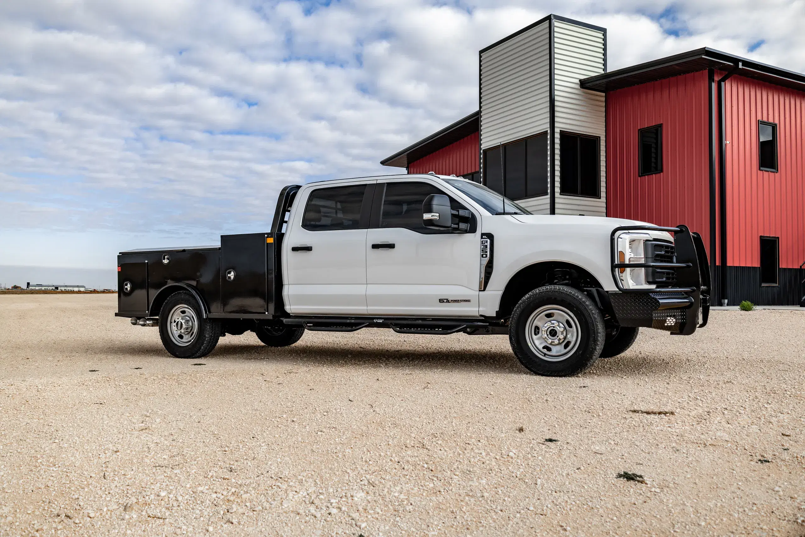 White Ford with a black Apollo service body at the Legend X building