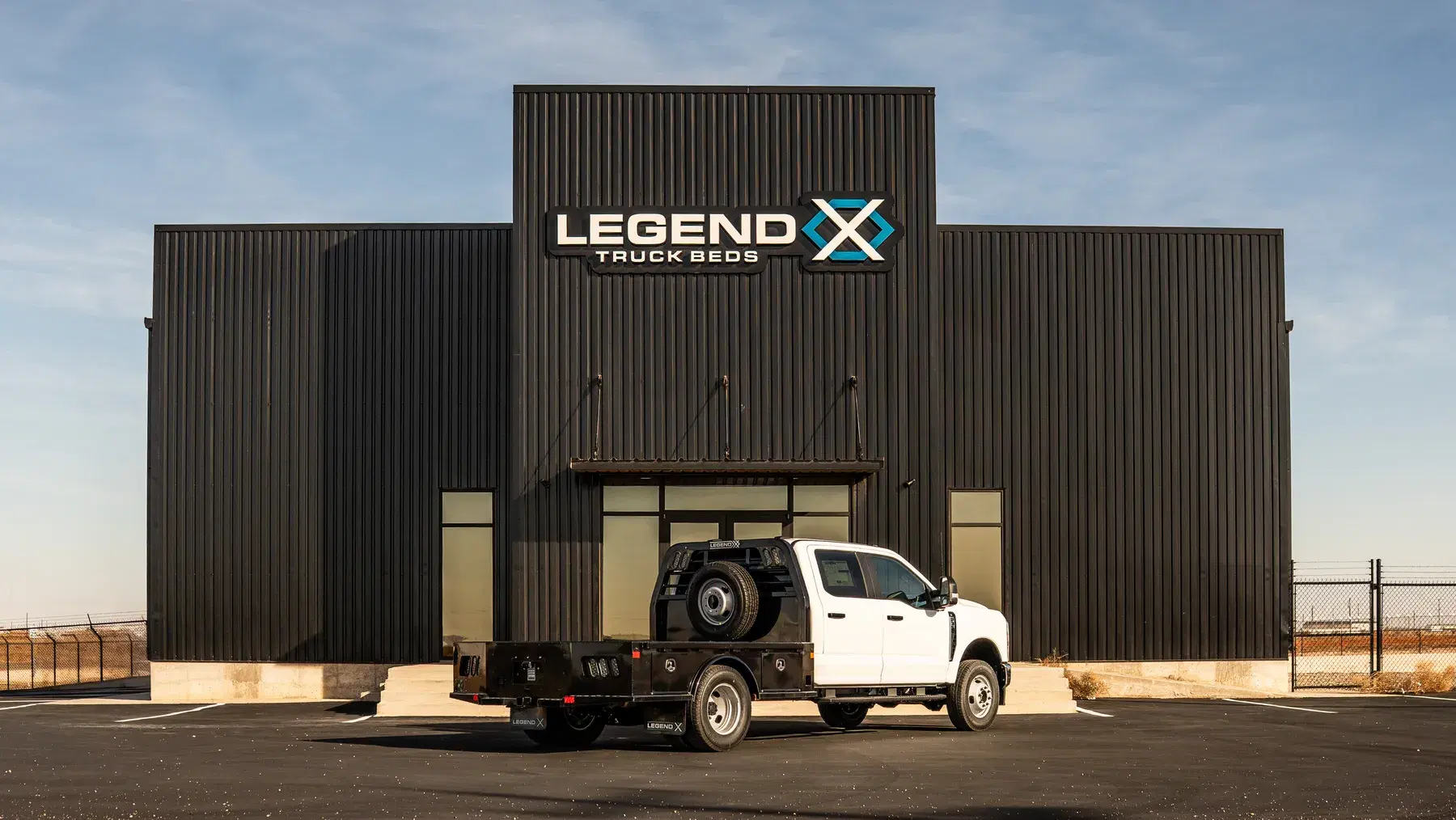 Legend X headquarters with a white Ford dually carrying a Viking bed parked at the entrance