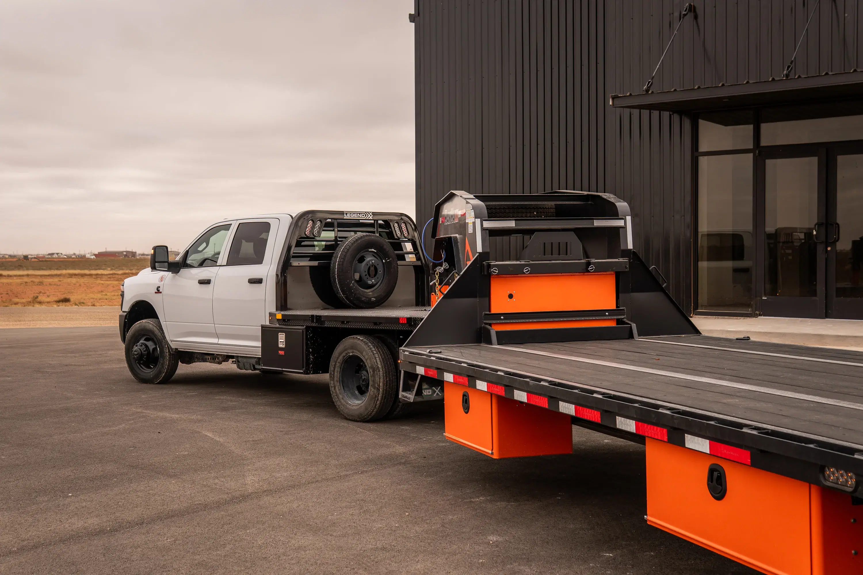 Ram 3500 equipped with a Legend X truck body and hitched to a gooseneck trailer