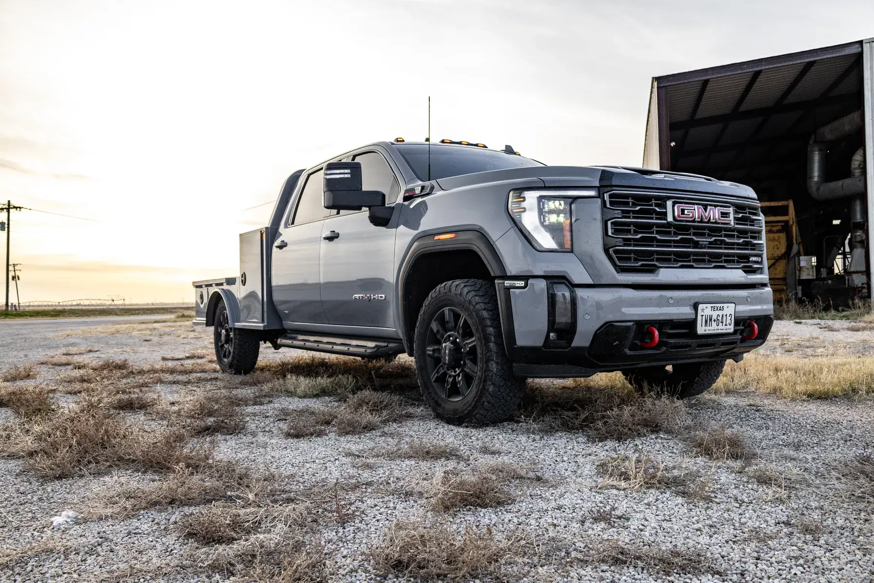 Gray color-matched Viking Pro bed on a GMC AT4 HD at golden hour