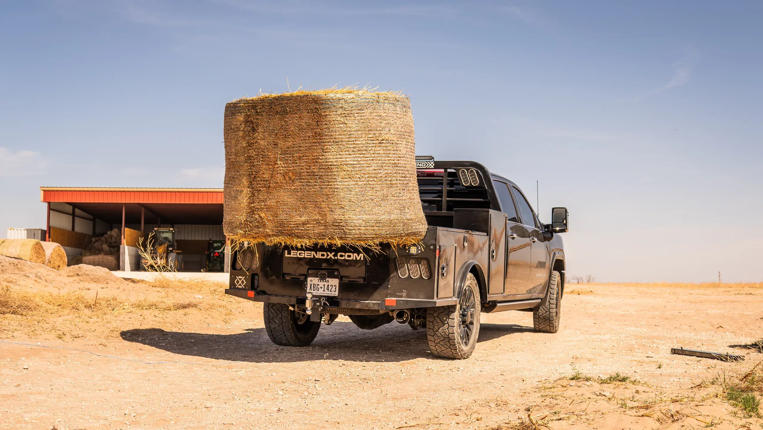 Apollo bed with a Spike attachment carrying a large round bale