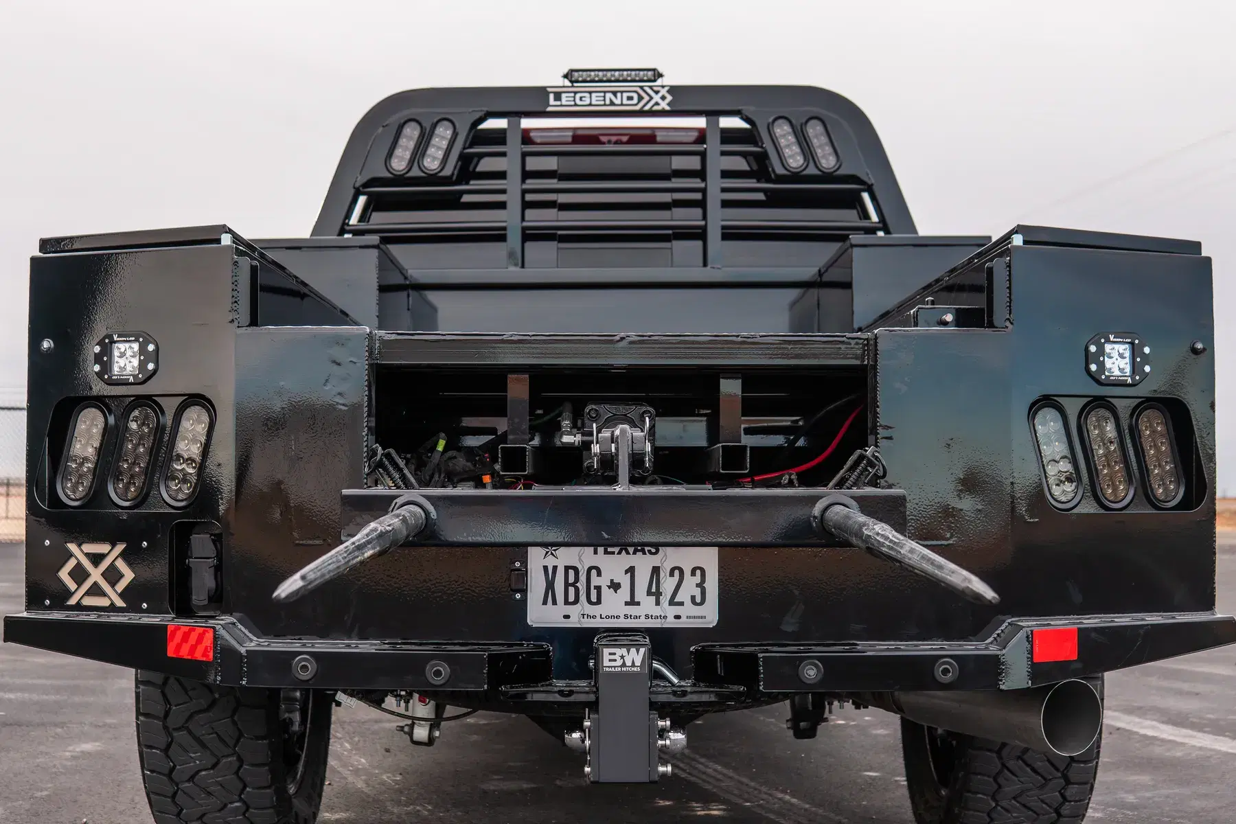 Rear of an Apollo bed with bale spikes deployed — LED light clusters and the Legend X badge